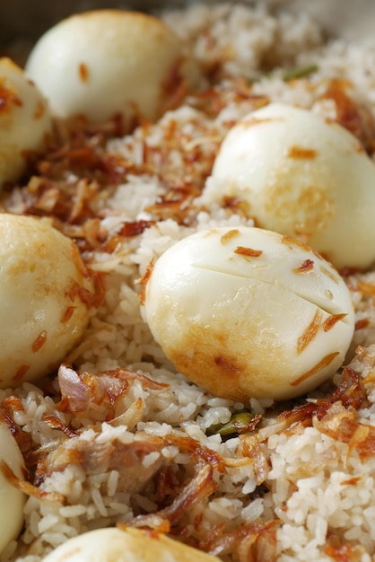 Cooked rice and egg in a bowl on table close up