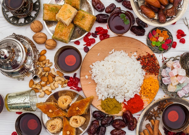 Cooked rice with spices and sweets on table