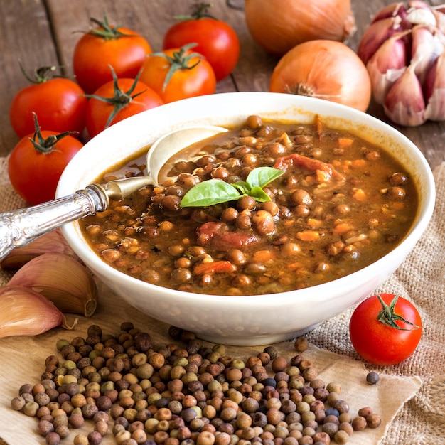 Photo cooked roveja stew with dried roveja and vegetables on a table close up