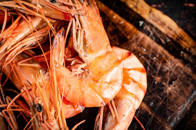 Cooked shrimp on a wooden cutting board