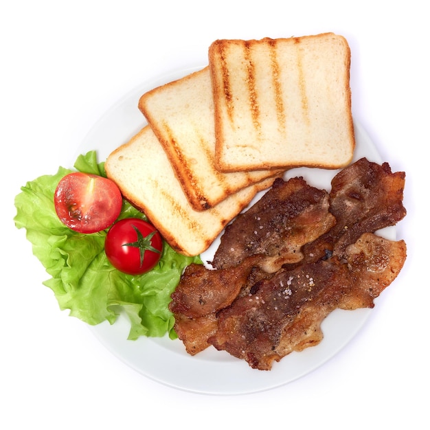 Cooked slices of bacon grilled toast and salad on white ceramic plate isolated on white background