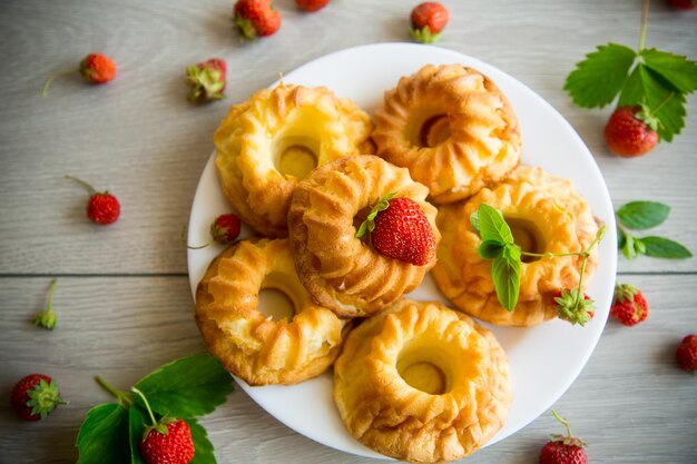 Cooked sweet curd cupcakes with fresh strawberries and mint