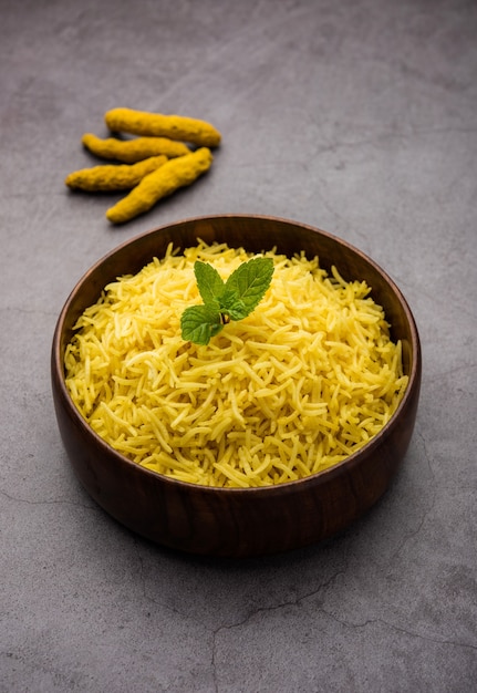 Cooked turmeric jasmine rice with powdered curcumin or haldi,\
indian food