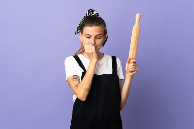 Cooker Slovak woman isolated on purple wall having doubts