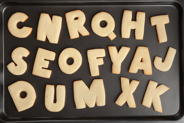 Cookie alphabet on baking tray closeup