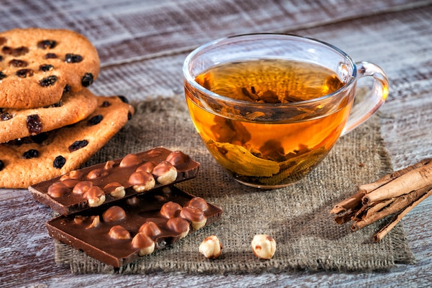 Cookie chocolate and tea on a wooden table