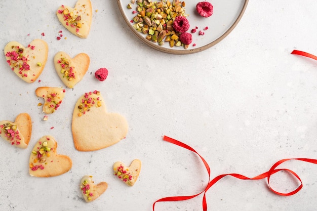 Cookie hearts with raspberries Background for Valentines Day Nut cookies Baking for lovers