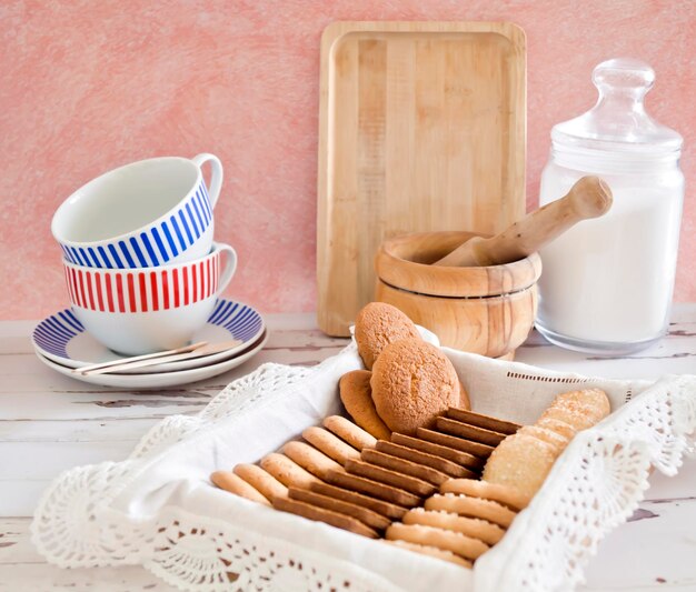 Photo cookie tray on a white wooden table and pink background