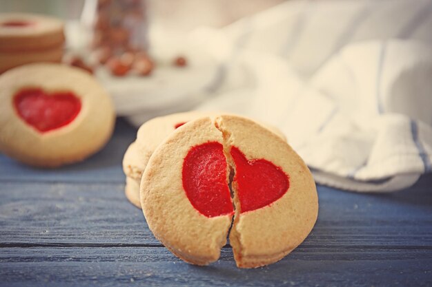 Cookie with heart shape on wooden table closeup