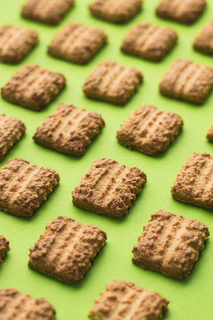 Cookies as pattern on green background