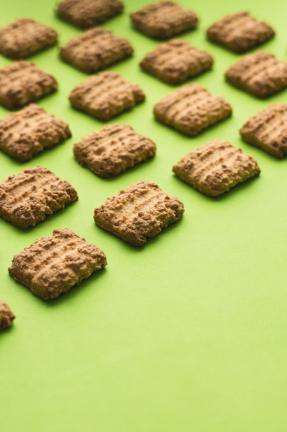 Cookies as pattern on green background