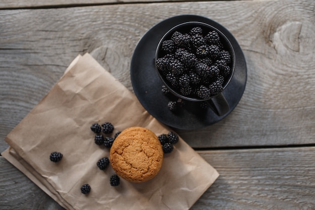 Cookies and blackberries on a wooden background