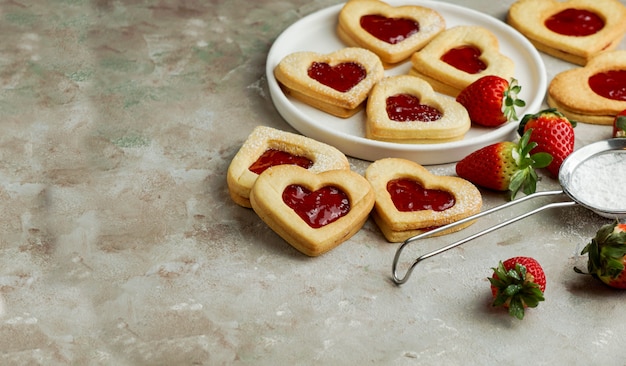 Cookies in the form of hearts with strawberry jam, St. Valentine's day consept