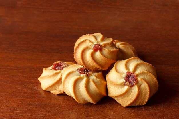 Cookies lying on a wooden table close-up.