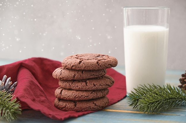 Cookies and milk for Santa Clause on wood background