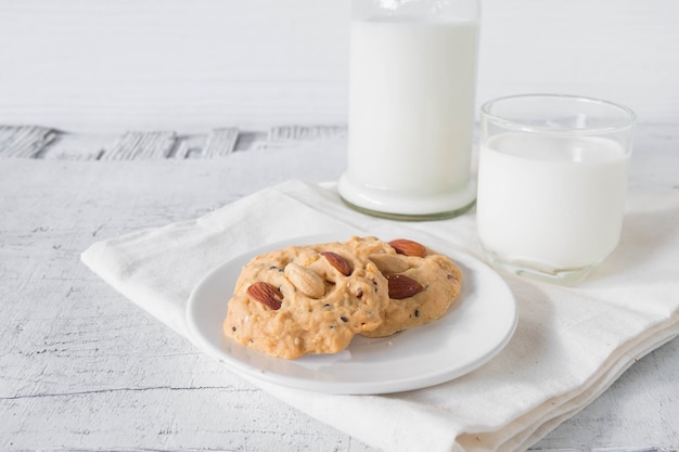 Cookies and milk on white wooden background