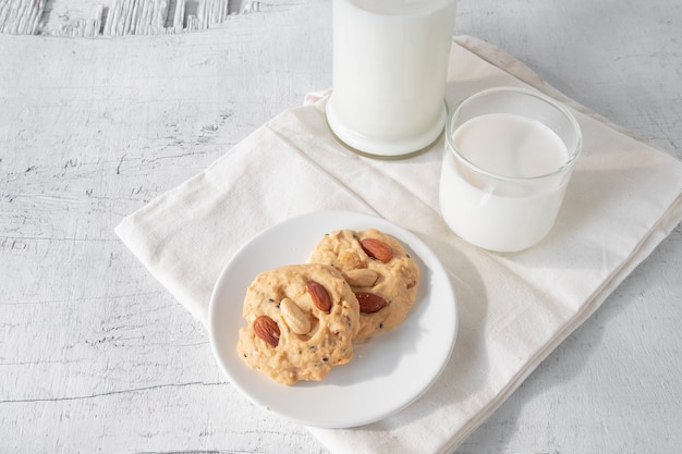 Cookies and milk on white wooden background