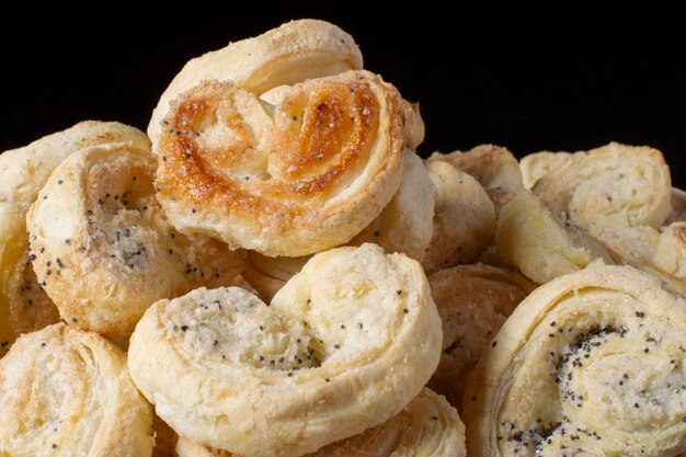 Cookies puff pastry ears on a dark background