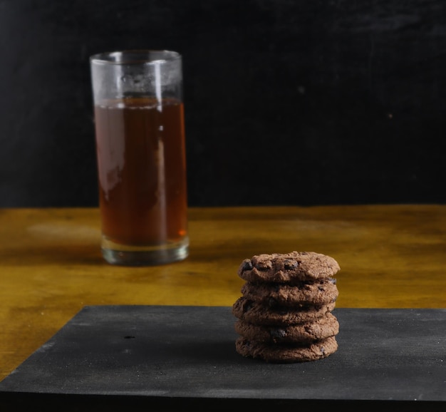 cookies and tea on black background