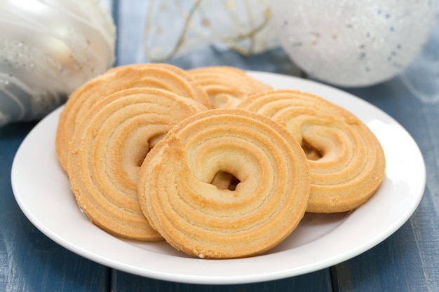 Cookies on white dish on blue wood