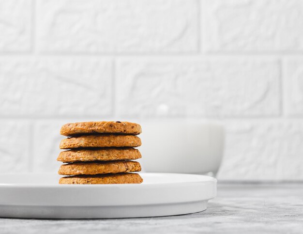 Photo cookies on a white plate on a light background