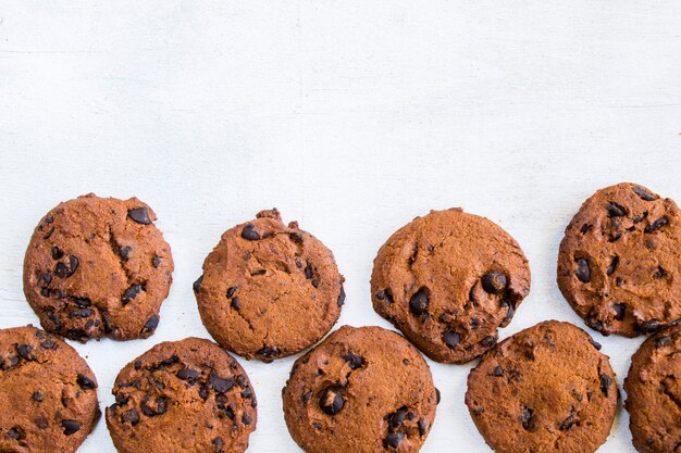 Cookies on white wooden table, top view