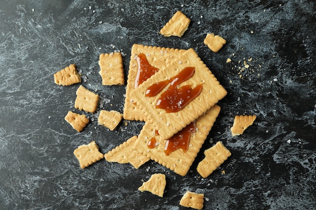 Cookies with caramel on black smokey background