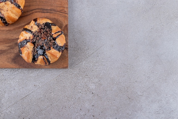 Cookies with chocolate coating placed on a stone table .