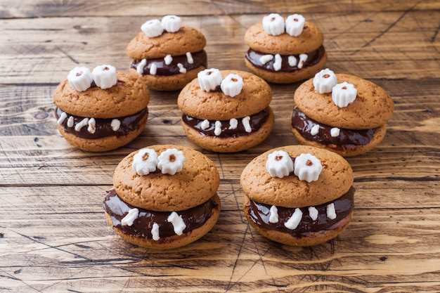 Photo cookies with chocolate paste in the form of monsters for halloween