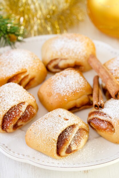 Cookies with cinnamon on white plate