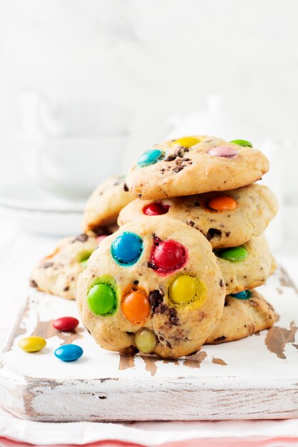 cookies with colorful chocolate sweets in sugar glaze