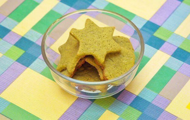 Cookies with green tea matcha in star shape and heart shape in a glass bowl