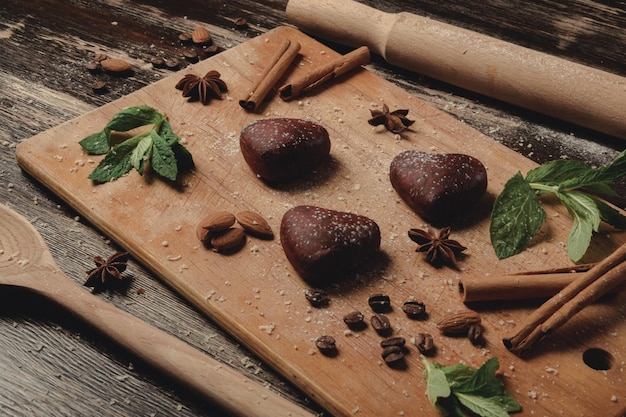 Cookies with mint in shape of heart on brown board gingerbread\
cookies cookie layout esthetics of holiday romance valentine39s day\
breakfast together brown board and brown gingerbread