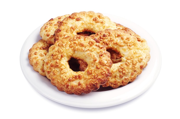 Cookies with nuts in plate on white background