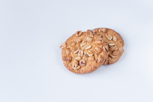 Cookies with nuts on a white wall, Delicious cookies on a white wall