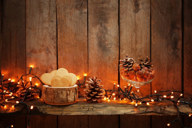 Foto biscotti con pigne e nocciole su legno