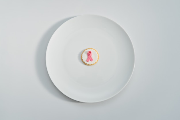 Cookies with pink ribbon as sign of breast cancer