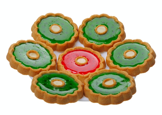 Cookies with red and green jelly on white plate isolated