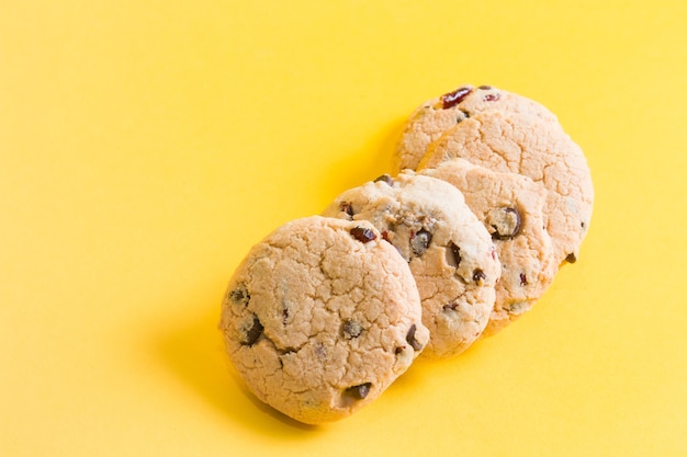 Cookies on a yellow surface, cookies with pieces of chocolate and lingonberry