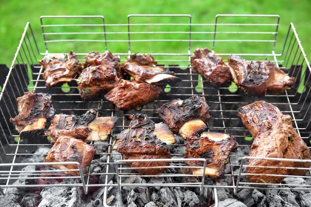 Cooking of appetizing juicy spare ribs outdoors