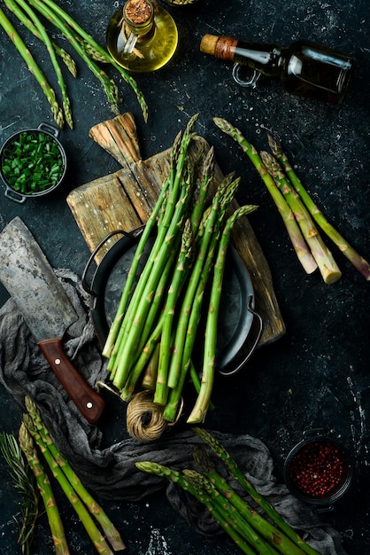 Cooking asparagus Green asparagus with spices on the table Healthy food On a stone background Top view