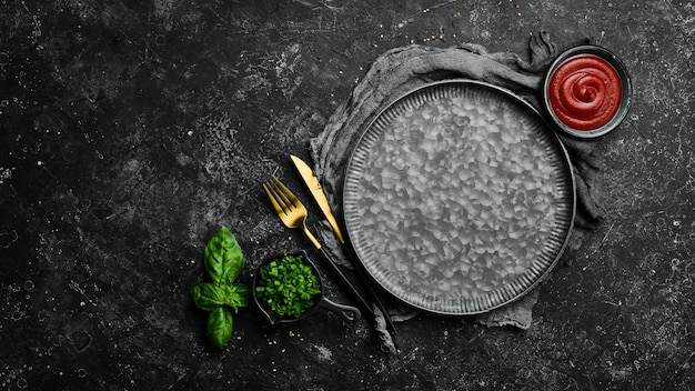 Cooking background metal plate vegetables and spices Top view On a stone background