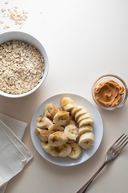 Cooking banana and peanut butter cookies Top view of ingredients bananas oatmeal peanut butter