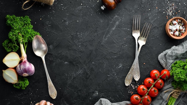 Cooking banner Vegetables and spices on a black background Free space for your text Rustic style