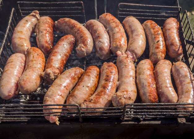 Cooking BBQ meat. Grilled meat sausages. Kebab fried in smoke.