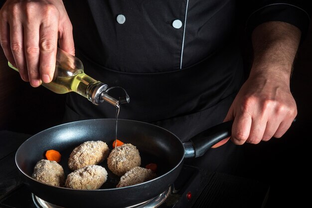 Cooking beef cutlets in grill pan with the hands of cook for copying the space text restaurant menu