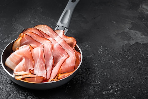 Cooking of Black Forest Ham in skillet Black background Top view Copy space