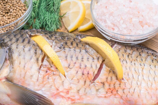 Cooking carp stuffed with lemon slices closeup