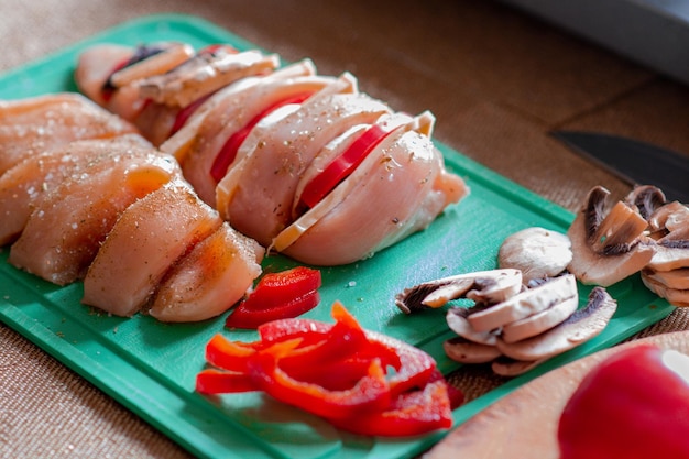 Cooking chicken french with vegetables on baking tray