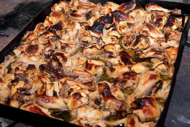 Cooking chicken in the kitchen slices of meat on a baking sheetxA